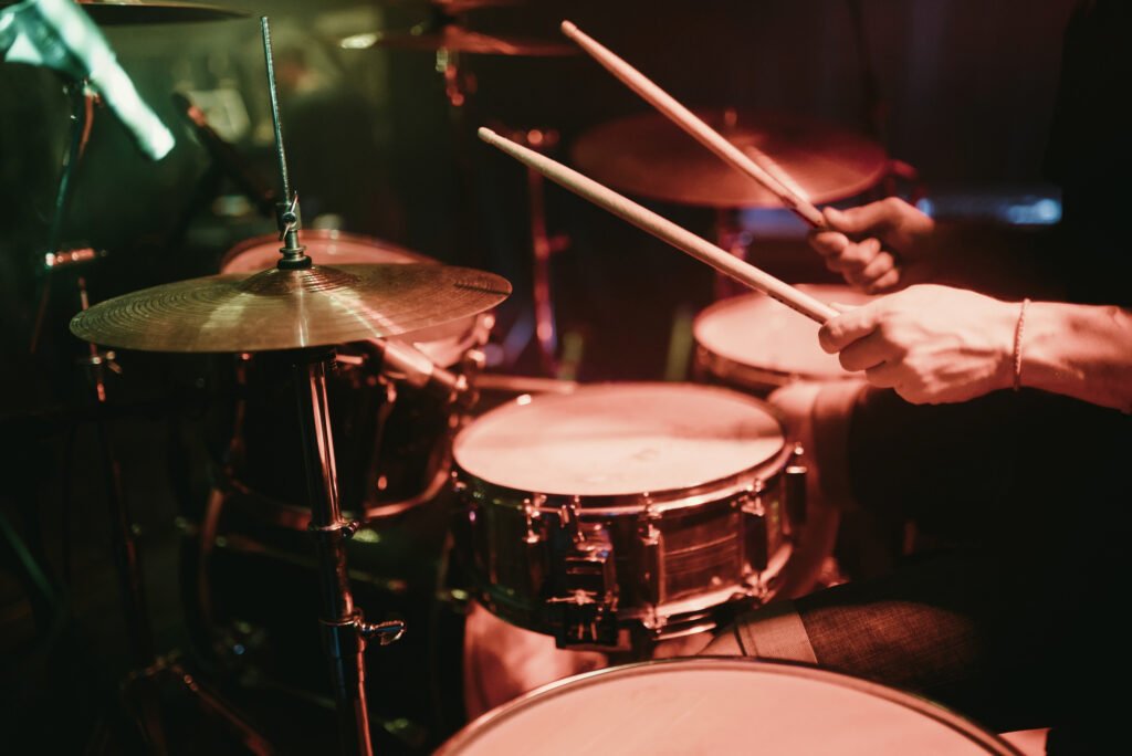 Drummer playing his drum kit on concert